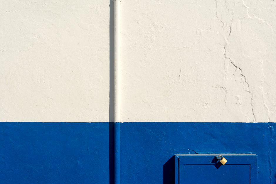 A painted white and blue exterior wall.